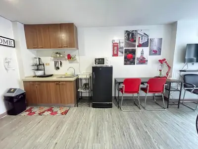 a kitchen with a table and chairs and a refrigerator at Modern Condotel in Ortigas good up to 8 pax in Manila