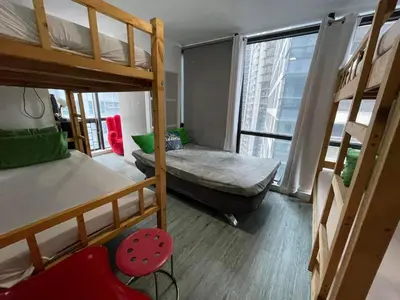 a room with two bunk beds and a window at Modern Condotel in Ortigas good up to 8 pax in Manila