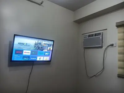 a flat screen tv on a wall in a room at Deca Cubao Budget Condo by Ashti in Manila