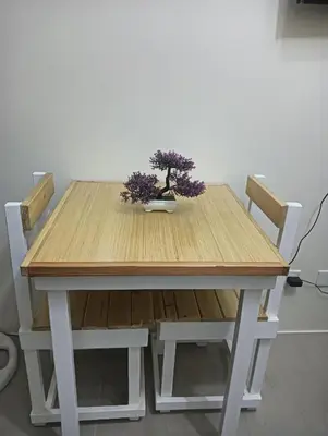 a wooden table with two bonsai plants on it at Deca Cubao Budget Condo by Ashti in Manila