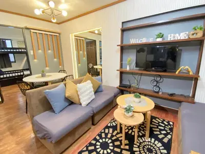 a living room with a couch and two tables at East Raya Gardens Pasig near Ortigas BGC Eastwood in Manila