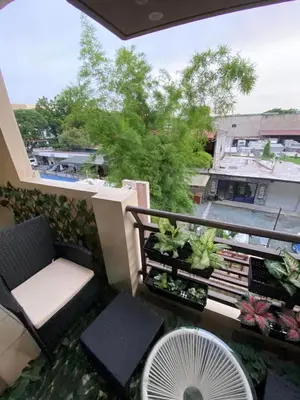 a balcony with a chair and a fan at East Raya Gardens Pasig near Ortigas BGC Eastwood in Manila