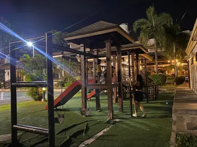 a group of people playing on a playground at night at East Raya Gardens Pasig near Ortigas BGC Eastwood in Manila
