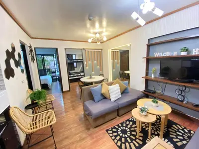 a living room with a couch and chairs and tables at East Raya Gardens Pasig near Ortigas BGC Eastwood in Manila