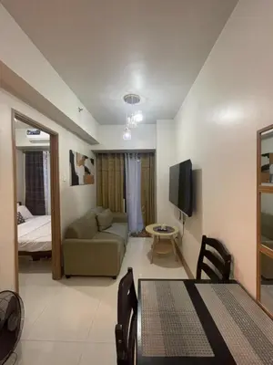 a living room with a couch and a bed at Gen Travel Hub in Manila