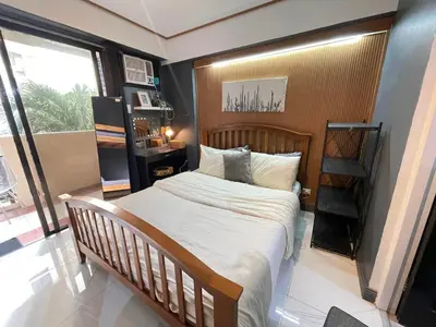 a bedroom with a large bed and a window at 3 bedroom 89sqm midrise condotel in Manila