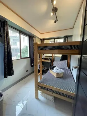 a bedroom with two bunk beds in a room at 3 bedroom 89sqm midrise condotel in Manila