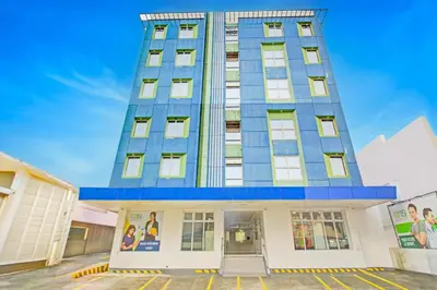 a tall blue building with windows on top of it at Townhouse College Residences in University Belt, Metro Manila in Manila