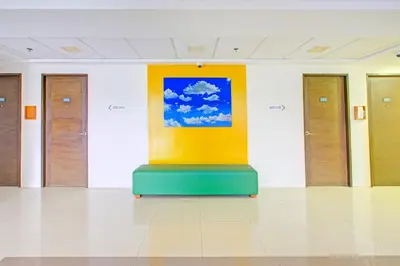 a room with a painting on the wall at Townhouse College Residences in University Belt, Metro Manila in Manila