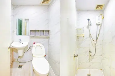 a bathroom with a toilet and a sink at Townhouse College Residences in University Belt, Metro Manila in Manila