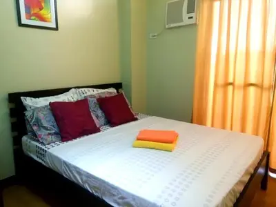 a bed with three pillows on top of it at Millionaire Tropical Paradise Penthouse Royal Palm in Manila