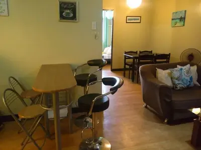 a living room with a couch and chairs and a table at Millionaire Tropical Paradise Penthouse Royal Palm in Manila