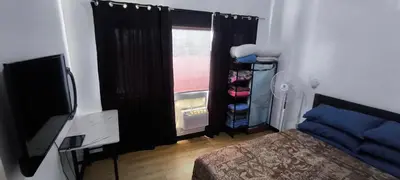 a bedroom with a bed and a window at DPMC Stay and Play Vacation Unit in Cainta