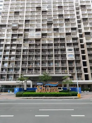 a large apartment building with a store in front of it at SHORE RESIDENCES NEAR Moa in Manila