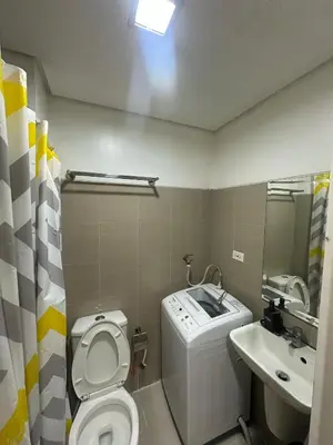 a small bathroom with a toilet and a sink at SHORE RESIDENCES NEAR Moa in Manila