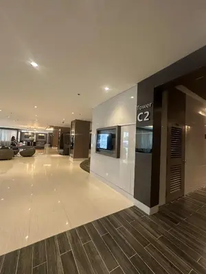 a lobby of a building with a sign on the wall at SHORE RESIDENCES NEAR Moa in Manila