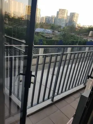 a balcony with a view of a street and buildings at Shore2n3 Residences MOA Pasay City Near NAIA Airport in Manila