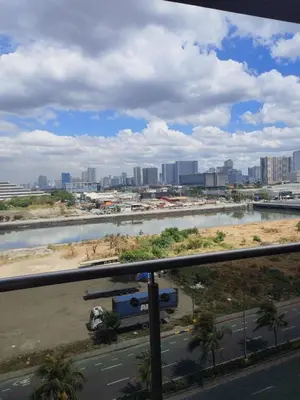 a view of a river with a city in the background at Shore2n3 Residences MOA Pasay City Near NAIA Airport in Manila