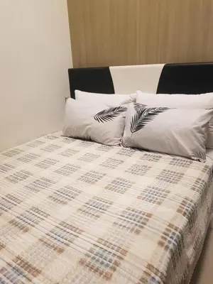 a bed with two pillows on top of it at Shore2n3 Residences MOA Pasay City Near NAIA Airport in Manila