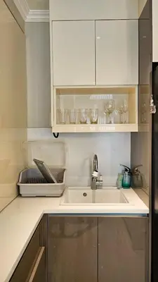 a kitchen with a sink and a counter top at Poblacion Studio Apartment with Balcony in Manila