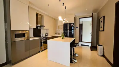 a kitchen with a white island in a room at Poblacion Studio Apartment with Balcony in Manila