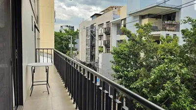 a stool sitting on a balcony of a building at Poblacion Studio Apartment with Balcony in Manila