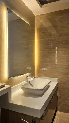 a bathroom with a sink and a mirror at Poblacion Studio Apartment with Balcony in Manila
