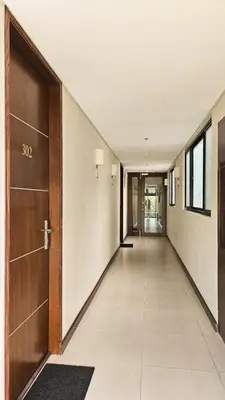 an empty hallway with a wooden door at Poblacion Studio Apartment with Balcony in Manila