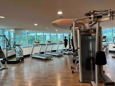 a gym with a bunch of treadmills at 2BR in Central BGC in Manila