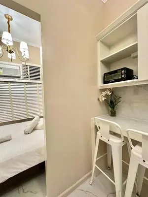 a bedroom with a desk and a bed in a room at Studio Two Condominium, Alabang AMBER -Fiber WI-FI Netflix ready in Manila
