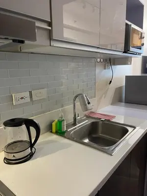 a kitchen counter top with a sink and a counter top at Destina, 100Mbps at Air Residences, Makati, MetroManila, Netflix in Manila