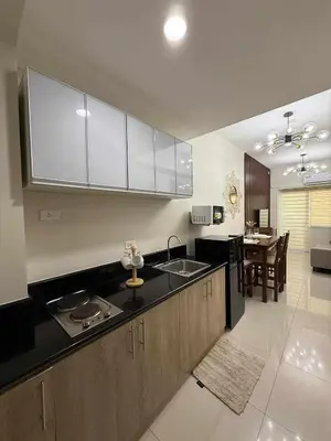 a kitchen with a sink and a counter top at Stylish and Comfy Condominium in Manila