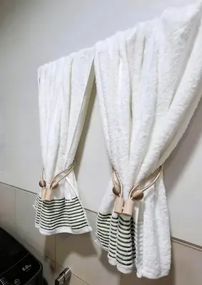 a pair of white curtains hanging on a wall at Stylish and Comfy Condominium in Manila