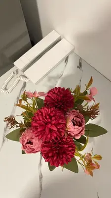 a bouquet of red flowers sitting on a table at Staycation Bliss at Fame in Manila