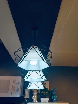 a light fixture hanging from a ceiling in a room at Cloves Den Binangonan Your Ultimate Cinema Date in Binangonan