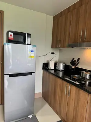 a kitchen with a refrigerator and a microwave at M S Staycation in Manila