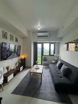 a living room with a couch and a tv at M S Staycation in Manila