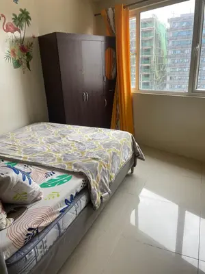 a bed in a room with a window and a bedskirtspectspectspectspects at Big cut room 3beds 1103 tower A in Manila
