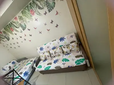 a bedroom with a bed with butterflies on the wall at Big cut room 3beds 1103 tower A in Manila