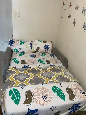a bed with a comforter and pillows on it at Big cut room 3beds 1103 tower A in Manila