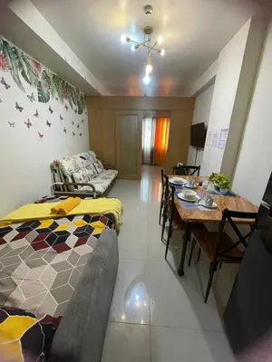 a living room with a bed and a dining table at Big cut room 3beds 1103 tower A in Manila