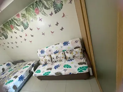 a small bedroom with a bed and butterflies on the wall at Big cut room 3beds 1103 tower A in Manila