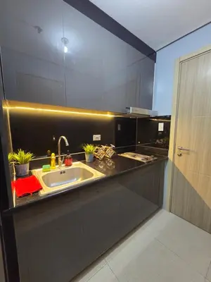 a kitchen with a sink and a large mirror at Cozy Corner at Shore 2 in Manila