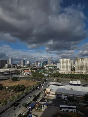 a view of a city with a street and buildings at Cozy Corner at Shore 2 in Manila