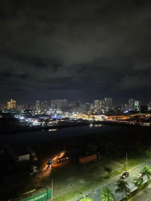 a night view of a city with a parking lot at Cozy Corner at Shore 2 in Manila