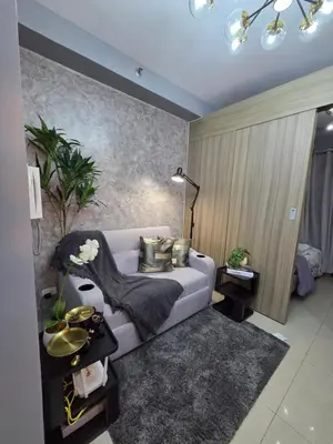 a living room with a couch and a table at Cozy Corner at Shore 2 in Manila