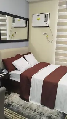 a bedroom with a bed and a air conditioner at Premium Studio in Pioneer Mandaluyong in Manila