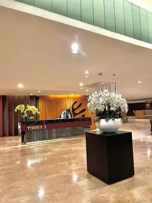 a lobby with a vase of flowers on a table at Staycation Shore 2 Residences Tower 2 Pasay City in Manila