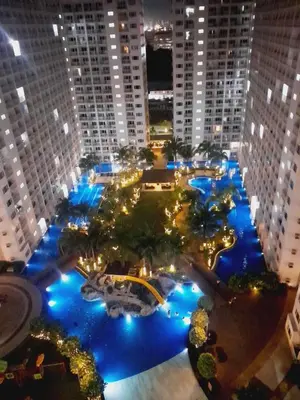 an aerial view of a large pool at night at SMDC SHORE 1 Residences, TOWER A in Manila