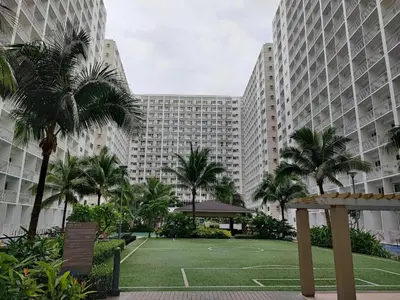 a park with palm trees in front of tall buildings at SMDC SHORE 1 Residences, TOWER A in Manila